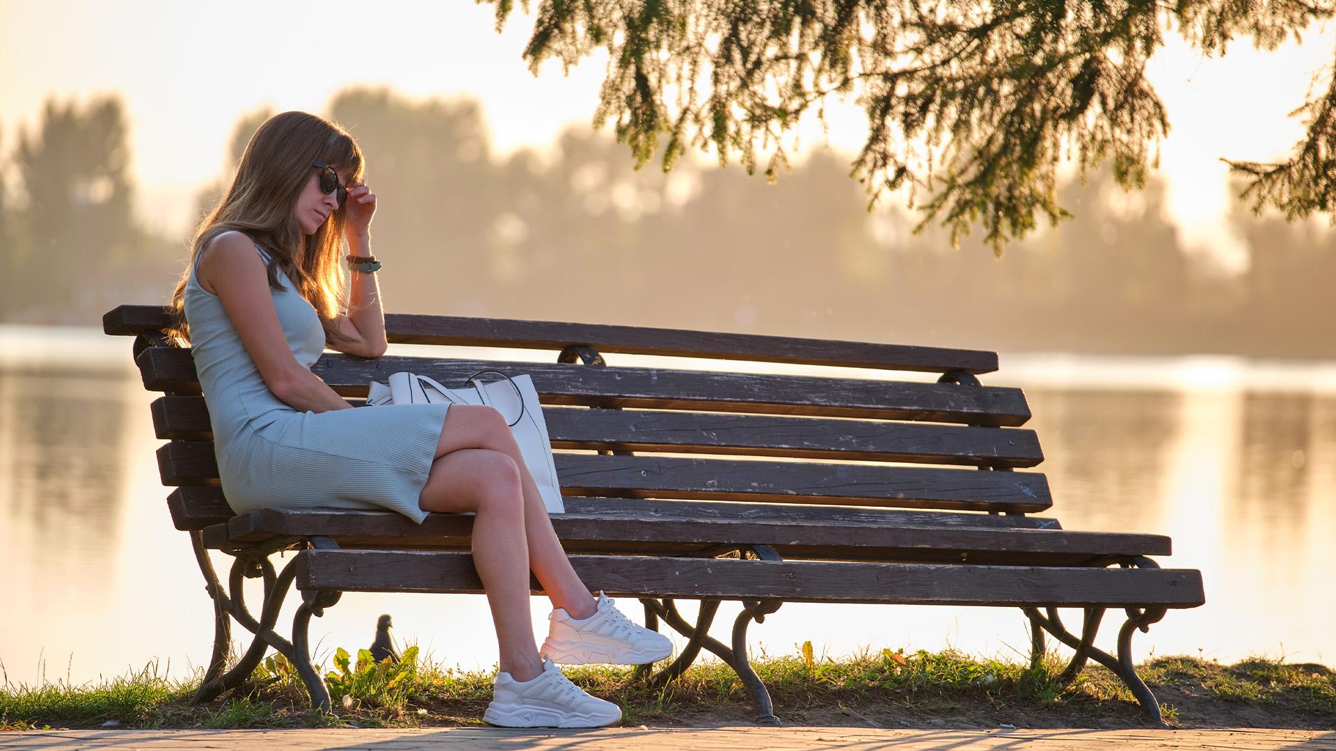 Sad Woman Sitting On Bench Image